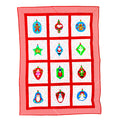 A square quilt or blanket with a red and white chevron border and a 3x4 grid of white panels, each featuring a colorful Christmas ornament illustration in red, green, blue, and gold.