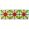 A rectangular quilted table runner featuring a repeating pattern of green Christmas trees on white panels, separated by red X-shaped centers and dark green borders.