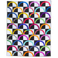 A square quilted textile featuring a black and white checkerboard pattern with repeating colorful semicircle arcs in many bright hues, photographed flat against a white background.