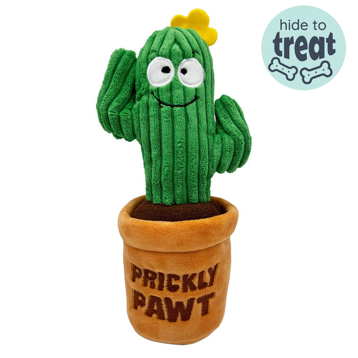 Dog with Seek 'n Treat Prickly Pawt Dog Toy on a white background.